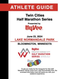 Event poster for the twin cities half marathon series at lake normandale park on june 23, 2024, sponsored by hy-vee, featuring red and black text on a white background.