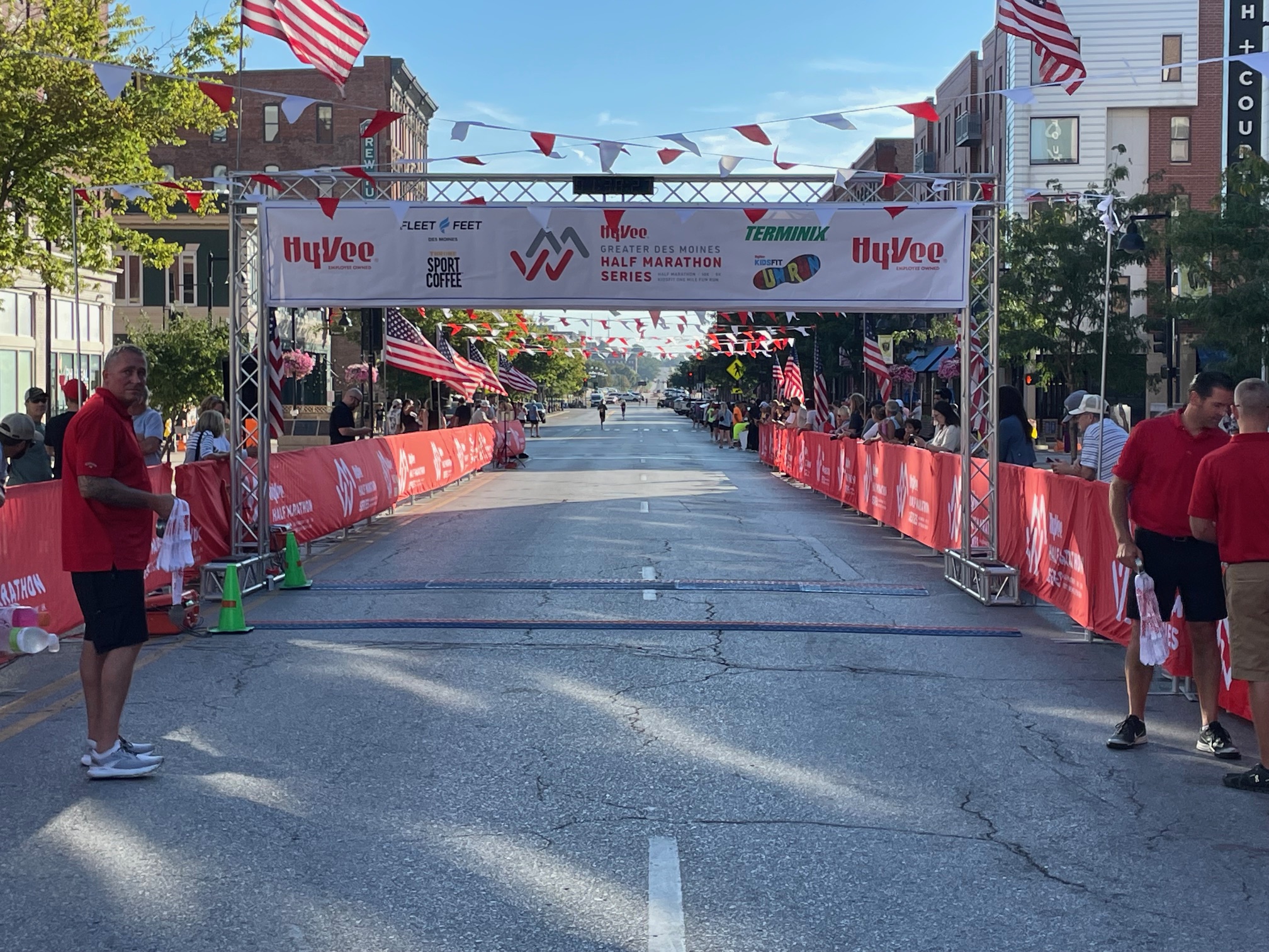 Starting line of a half marathon event with people and decorations in a city street.